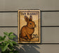 Tan rabbit postage stamp on a wall