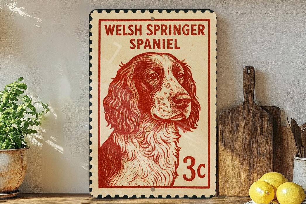 A Welsh Springer Spaniel dog is depicted on a red and white postage stamp, which is placed on a wooden surface next to a wooden cutting board and some lemons.