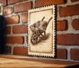 A wooden wheelbarrow is depicted on a brick wall, with a decorative border around it.