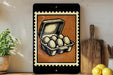 a framed illustration of a carton of eggs on a shelf, with a wooden cutting board and a potted plant nearby.