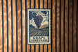 A vintage-style metal sign with a grape vineyard illustration and the text "GRAPE VINEYARD" is displayed on a wooden wall.
