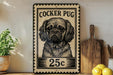 A vintage-style stamp featuring a Cocker Puff dog, with the text "COCKER PUG" and the denomination "25c" printed on it. The stamp is displayed on a shelf next to a wooden cutting board and some potted plants.