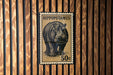 A metal stamp depicting a hippopotamus, with the text "HIPPOPOTAMUS 50c" printed on it.