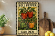 A metal sign with a colorful illustration of bell peppers and a garden setting, placed on a wooden shelf next to a potted plant and kitchen utensils.