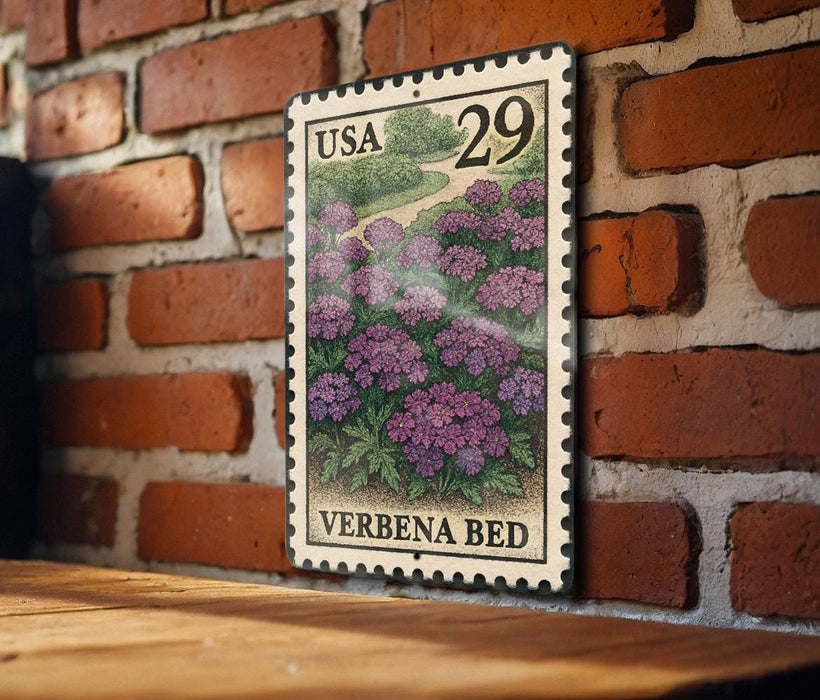 A US postage stamp featuring a field of purple flowers is displayed on a brick wall.