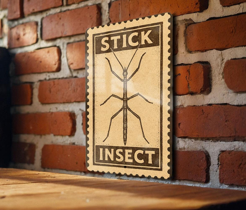 A wooden table with a brick wall in the background, and a framed sign with the word "STICK" and an illustration of a stick insect.
