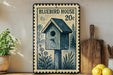 A vintage-style postage stamp featuring a blue birdhouse, placed on a wooden surface next to a wooden cutting board and a potted plant.