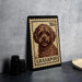 A metal stamp featuring a portrait of a dog, with the text "Lhasa poodle" printed on it.
