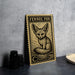 a wooden postcard with a fennec fox illustration, placed on a table next to some black camera lenses.