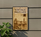 A vintage postage stamp-style sign is displayed on a wall, featuring an illustration of a cityscape and a bridge.
