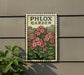A sign for the Phlox Garden, featuring a floral illustration of pink flowers against a green background.