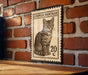 A wooden table with a vintage-style European Shorthair cat stamp on it, mounted on a brick wall.