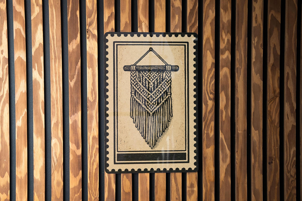 a decorative hanging piece with a geometric pattern, mounted on a wooden wall.