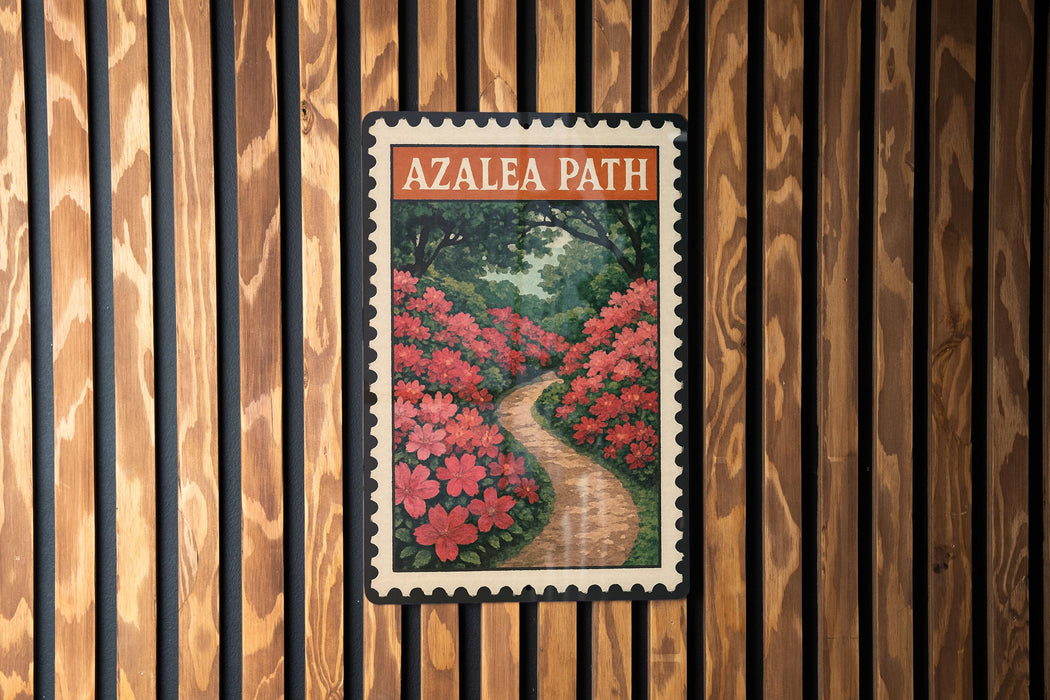 A framed image of a garden path with red flowers is displayed on a wooden wall.