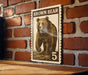 A brown bear illustration on a brick wall, with the text "BROWN BAY" and the number "5" below it.