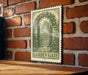 A vintage-style metal sign with a garden gate illustration is mounted on a brick wall.