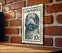 A metal sign featuring a dog's face on a brick wall.