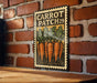 A vintage-style metal sign with a carrot illustration and the text "CARROT PATCH 29" is displayed on a brick wall.