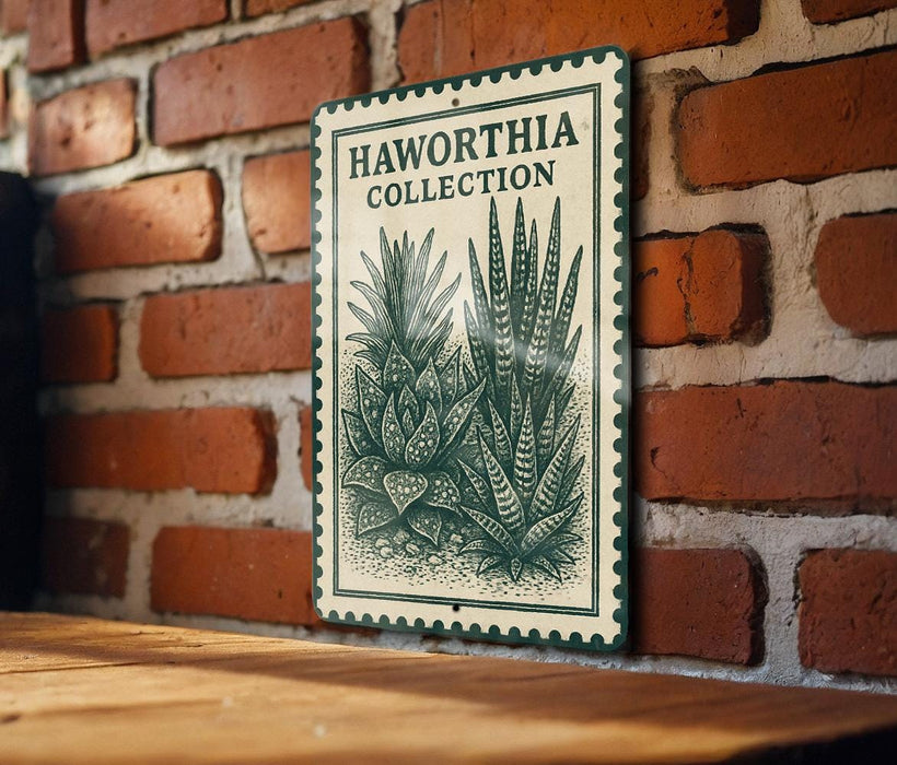 A metal sign with a green border and a drawing of a cactus plant is mounted on a brick wall.