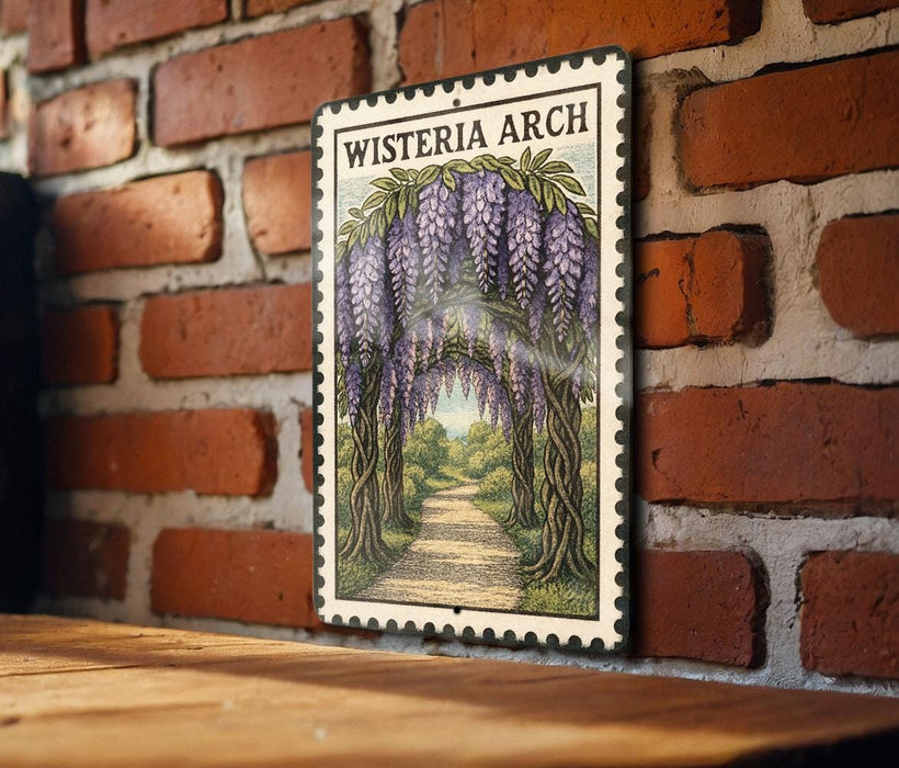 A framed illustration of a wisteria arch is displayed on a brick wall, with a wooden table below it.