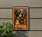 A metal sign with a picture of a dog wearing a barrel around its neck, with the word "CHUG" written below the image.