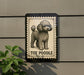 A sign featuring a poodle illustration, with the text "TOY PODLE" below the image.