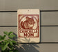 A sign with a chinchilla illustration and the text "CHINCHILLA MOM" is displayed on a wall.