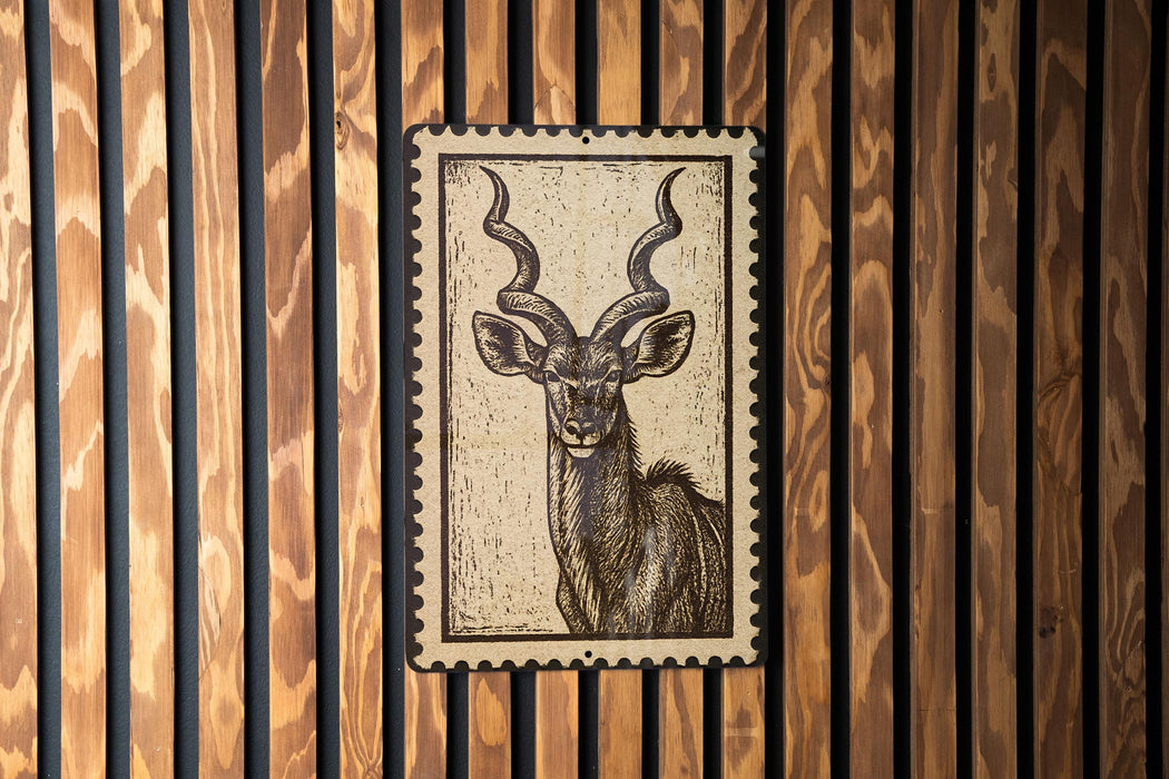 a close-up of a wooden wall with a framed image of a horned animal, likely a deer or antelope, prominently displayed on the wall.