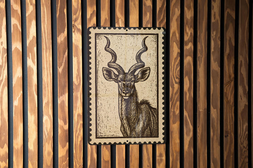 a close-up of a wooden wall with a framed image of a horned animal, likely a deer or antelope, prominently displayed on the wall.