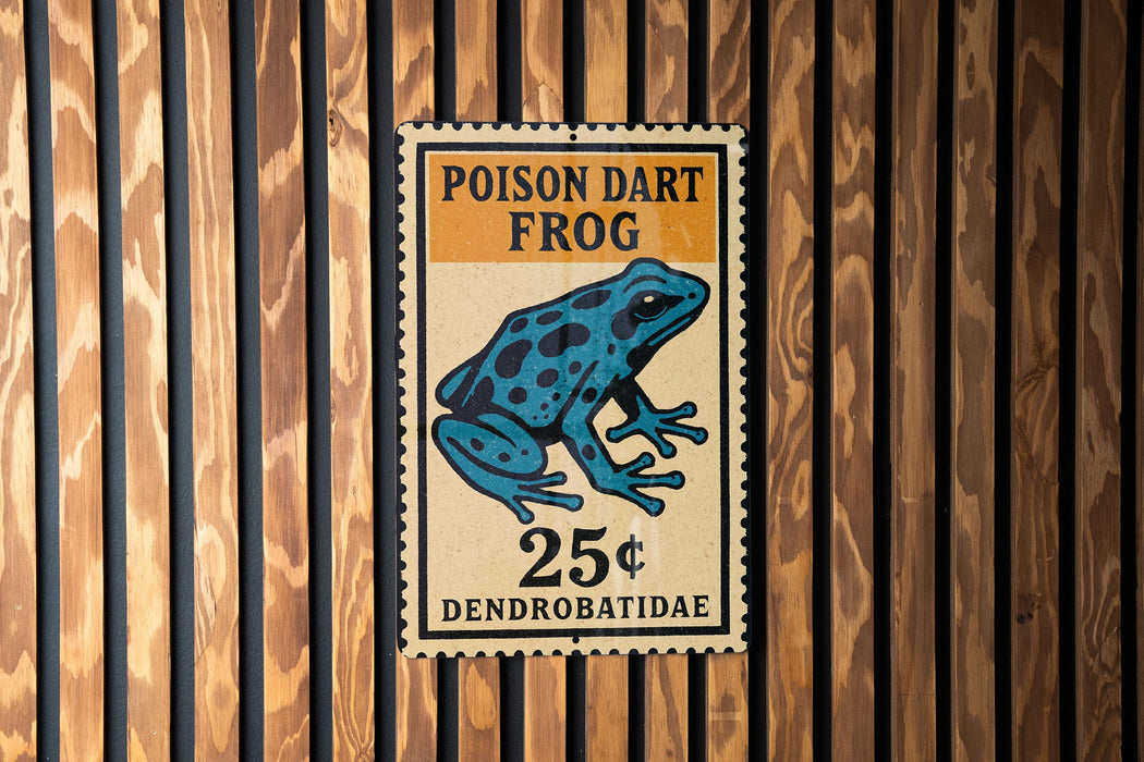 A sign for a Poison dart frog, which is a type of frog that is toxic to humans. The sign is mounted on a wooden wall.