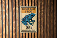 A sign for a Poison dart frog, which is a type of frog that is toxic to humans. The sign is mounted on a wooden wall.