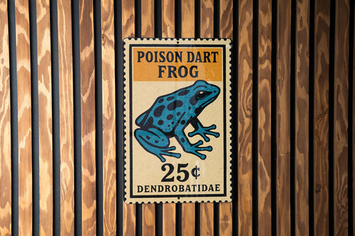 A sign for a Poison dart frog, which is a type of frog that is toxic to humans. The sign is mounted on a wooden wall.