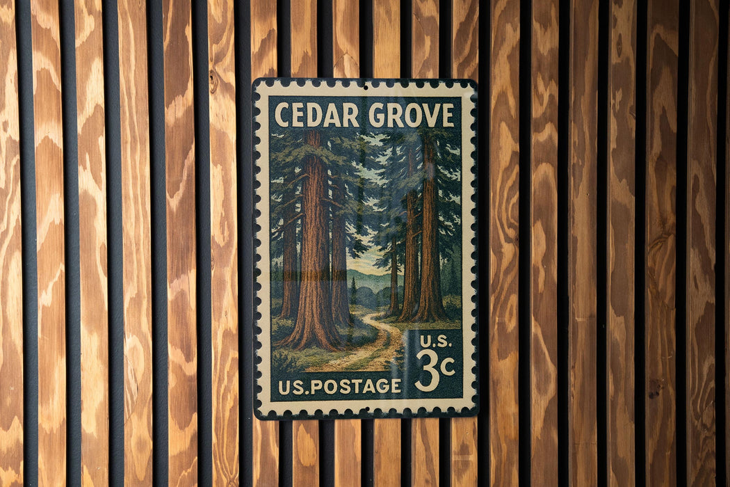 A vintage U.S. postage stamp featuring a forest scene, mounted on a wooden wall.