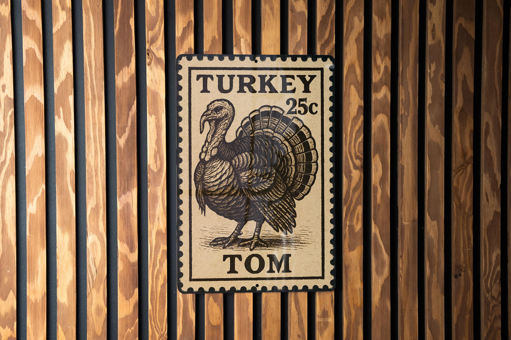 A metal stamp featuring a turkey on a wooden background.