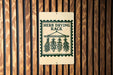 A sign that reads "Herb Drying Rack" is mounted on a wooden wall.