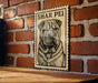 A wooden table with a framed image of a Shar Pei dog on it, mounted on a brick wall.