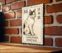 A Japanese bobtail cat illustration on a wooden surface, mounted on a brick wall.