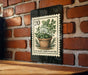 A metal sign with a stamp-like design hangs on a brick wall, featuring a potted plant illustration and the text "CULINARY HERB PLANTER".
