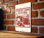 A sign on a brick wall that says "Berry Jam Making" with illustrations of a jar of jam and strawberries.