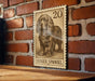 A wooden table with a framed image of a dog, specifically a Sussex Spaniel, on it.