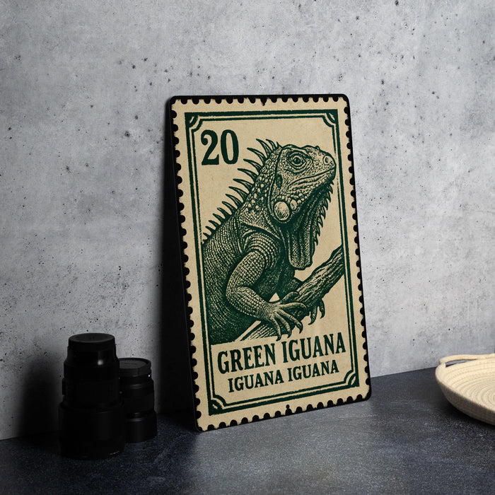A green and beige postage stamp featuring a detailed illustration of a green iguana, with the text "Green Iguana" and "Iguana Iguana" printed on it.