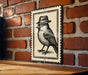 A black and white illustration of a bird wearing a hat is displayed on a brick wall.