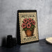 A metal sign with a floral design and the text "PETUNIA PLANTER" is displayed on a table.