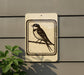 a sign depicting a bird perched on a branch.