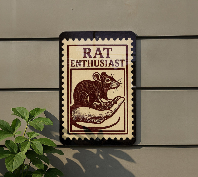 a sign with a mouse on it, mounted on a wall.