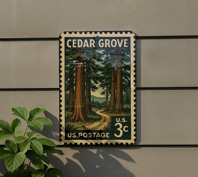 A vintage U.S. postage stamp depicting a scenic forest landscape, mounted on a wall next to a plant.