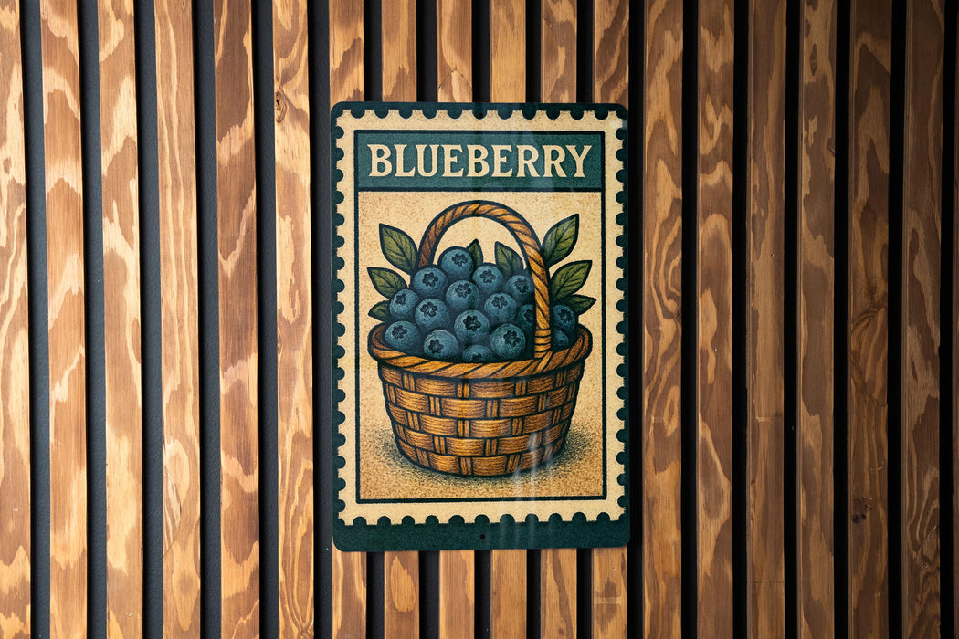 A metal sign with a basket of blueberries mounted on a wooden wall.