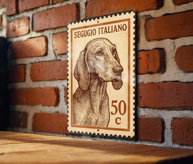 A wooden table with a brick wall in the background, featuring a framed Italian postage stamp depicting a dog.