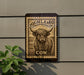 a sign with a cow illustration and the text "Highland Cow" on it, mounted on a wall.