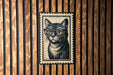 A black and white illustration of a cat wearing glasses is displayed on a wooden wall.